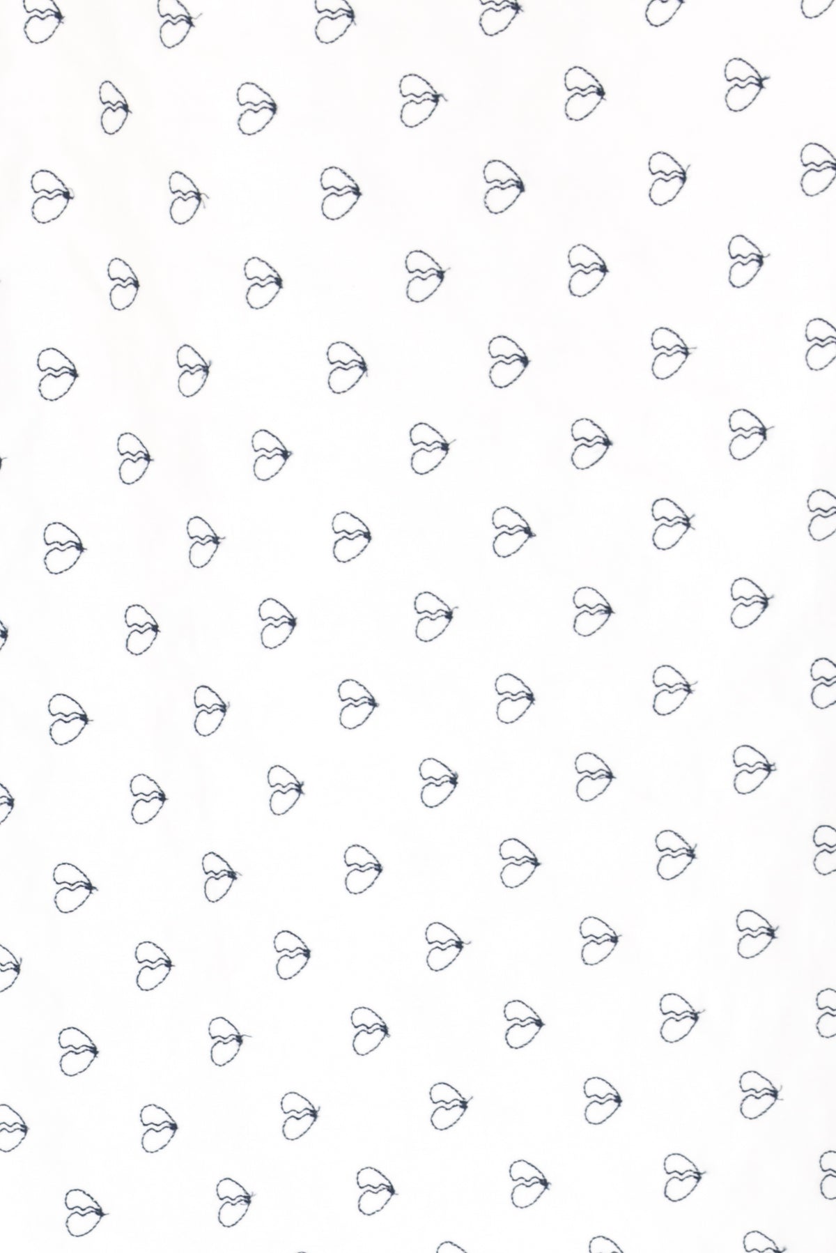 White fabric with small navy blue heart print, ideal for apparel and quilting projects