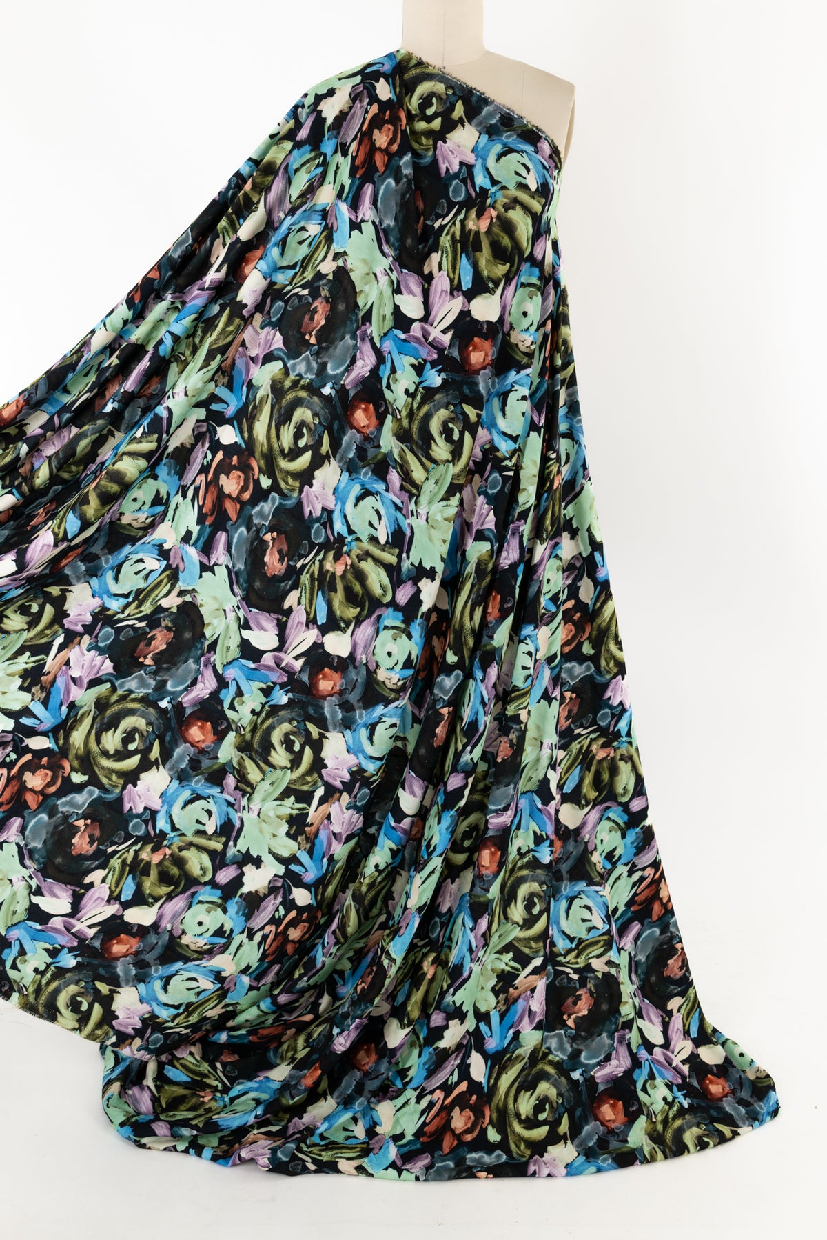 Vibrant floral print fabric with green, blue, and purple blooms on black background, ideal for apparel sewing