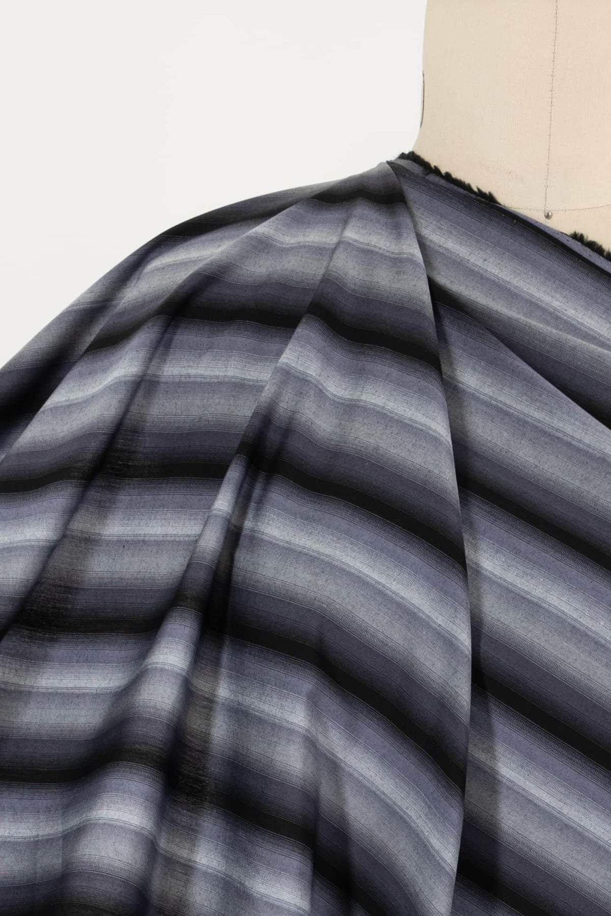 Gray striped woven fabric draped on mannequin, ideal for apparel sewing projects