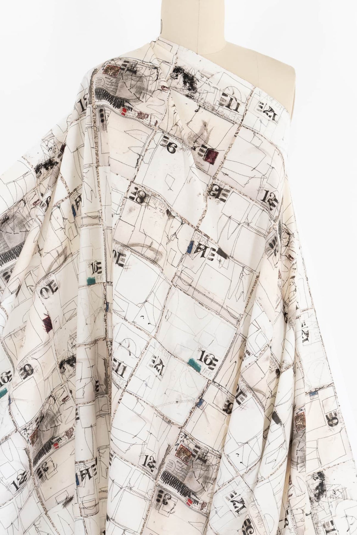 Abstract geometric print fabric with sketch-style numbers and lines, ideal for fashion sewing projects