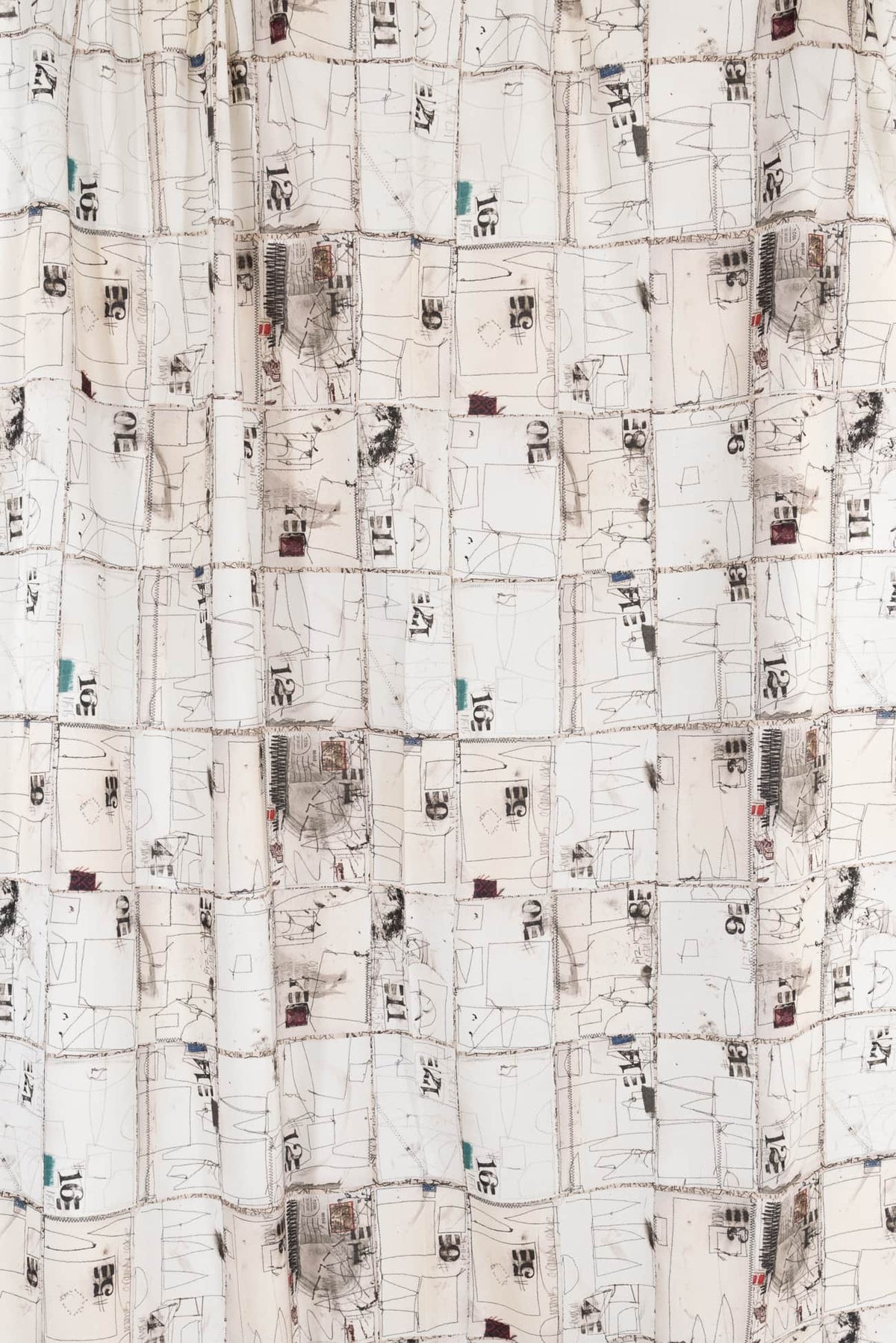 Abstract geometric print fabric with sketch-like squares, numbers, and lines for apparel sewing