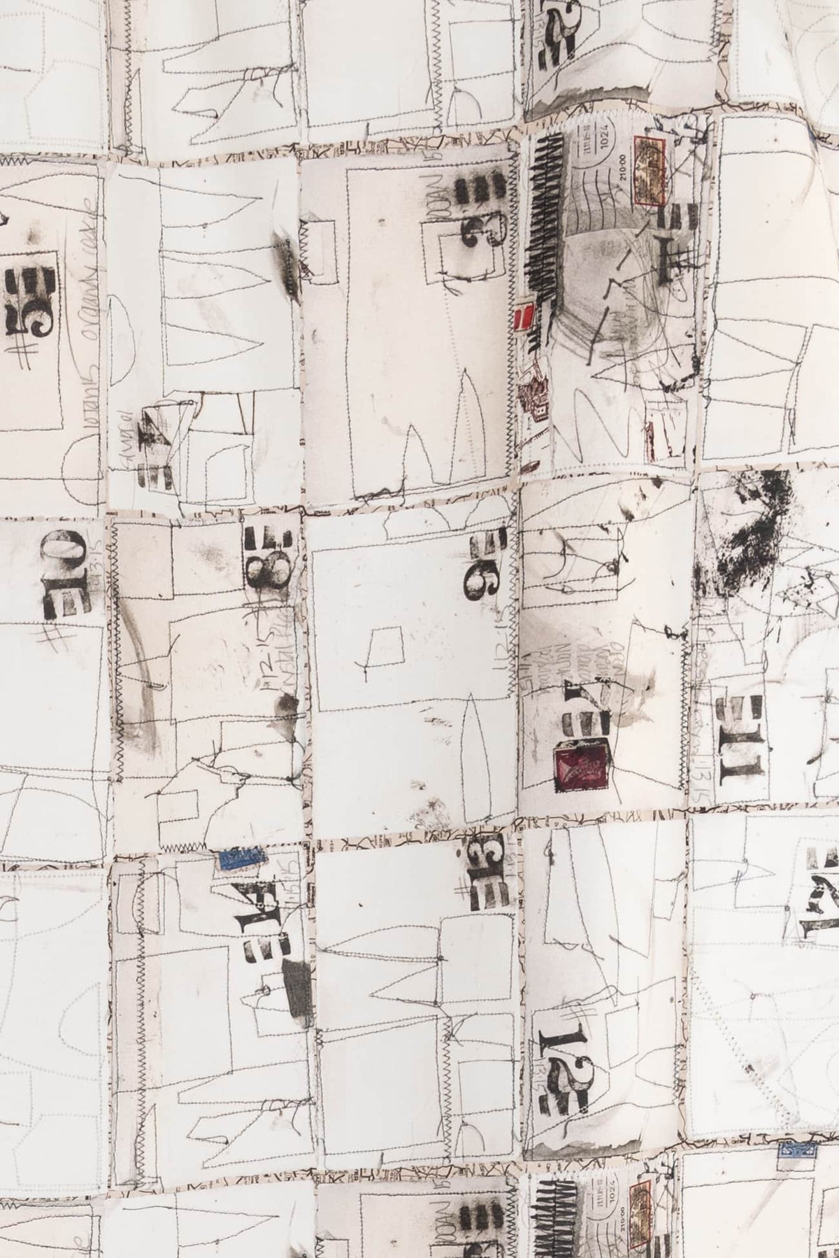 Abstract printed fabric with stitched grid, numbers, and sketch-like designs for creative sewing projects