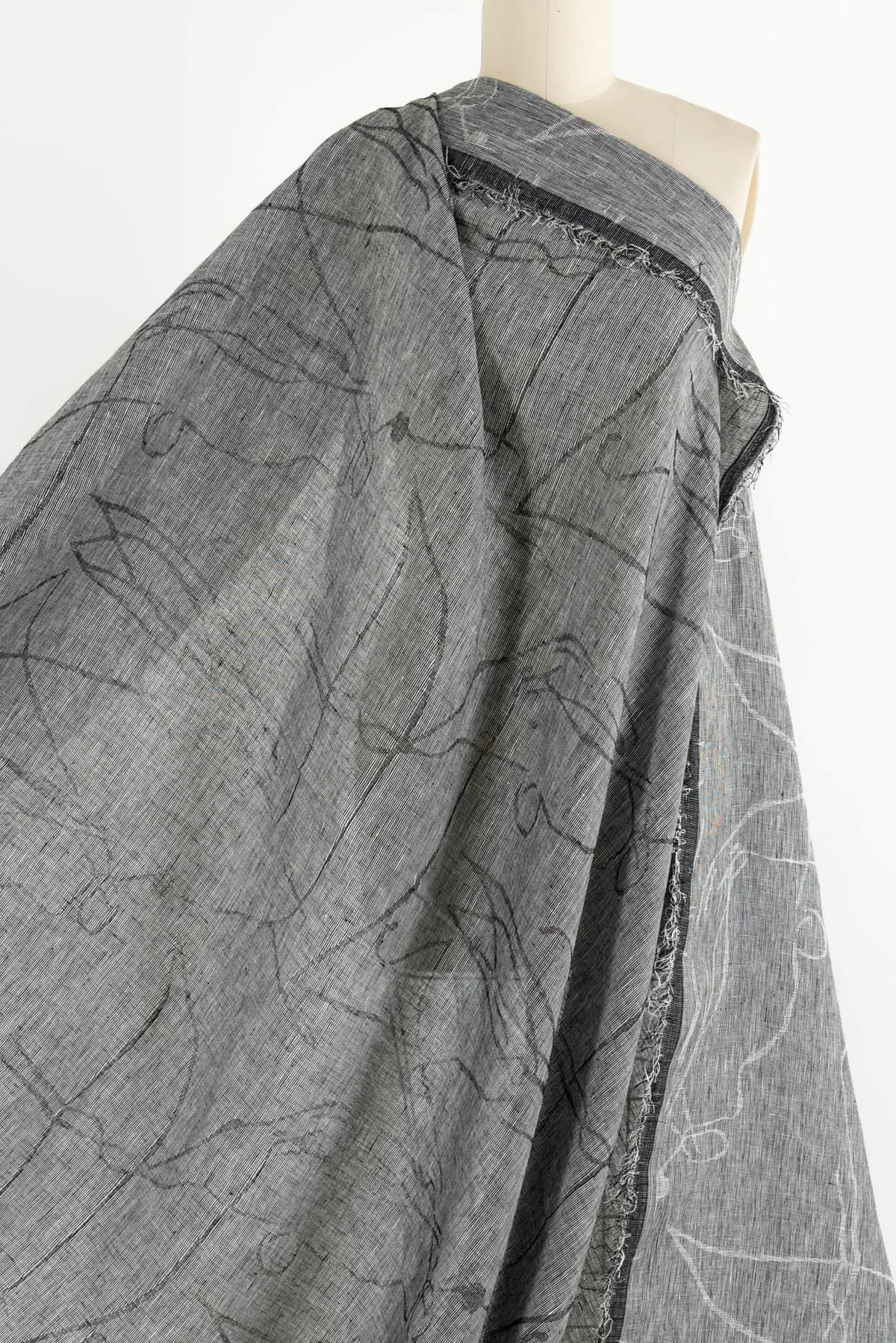 Gray abstract print fabric draped on mannequin, ideal for apparel sewing and fashion design projects