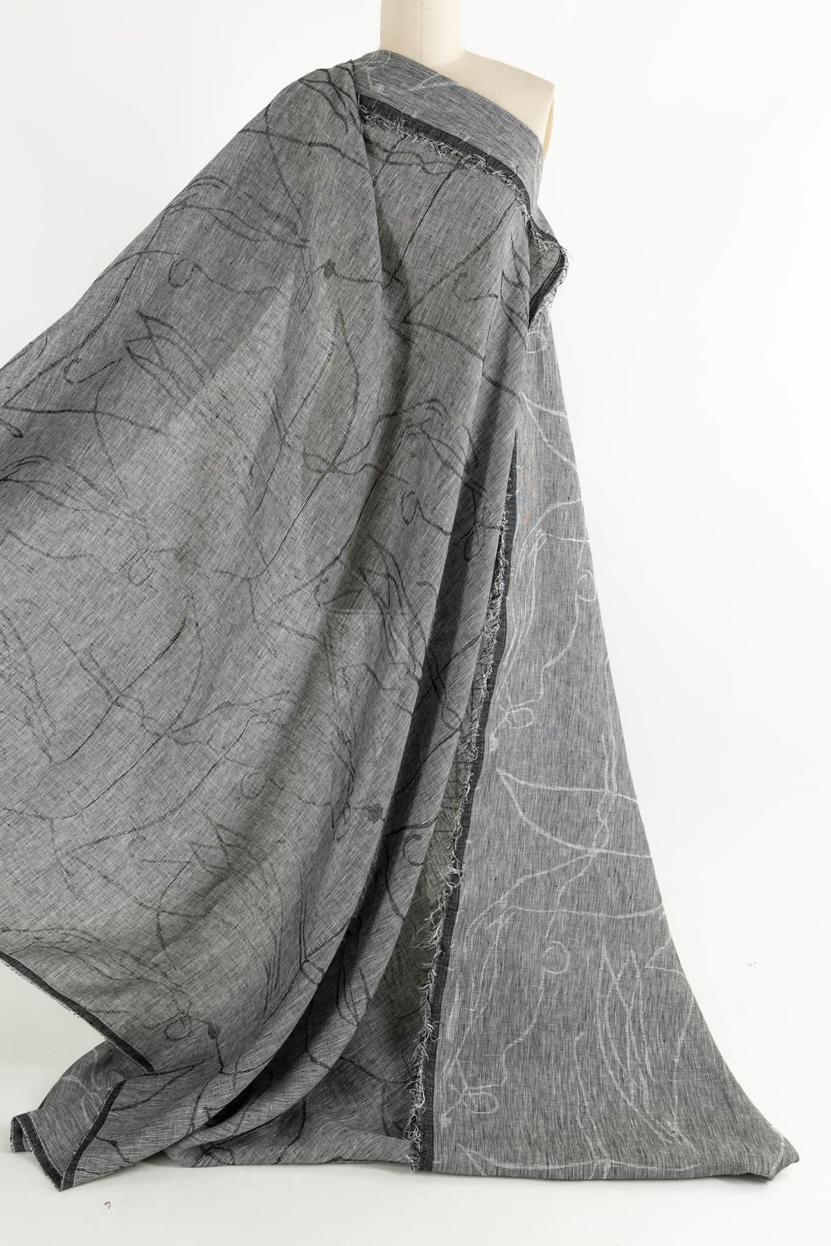 Gray abstract print fabric with black and white line patterns, ideal for apparel sewing and fashion projects