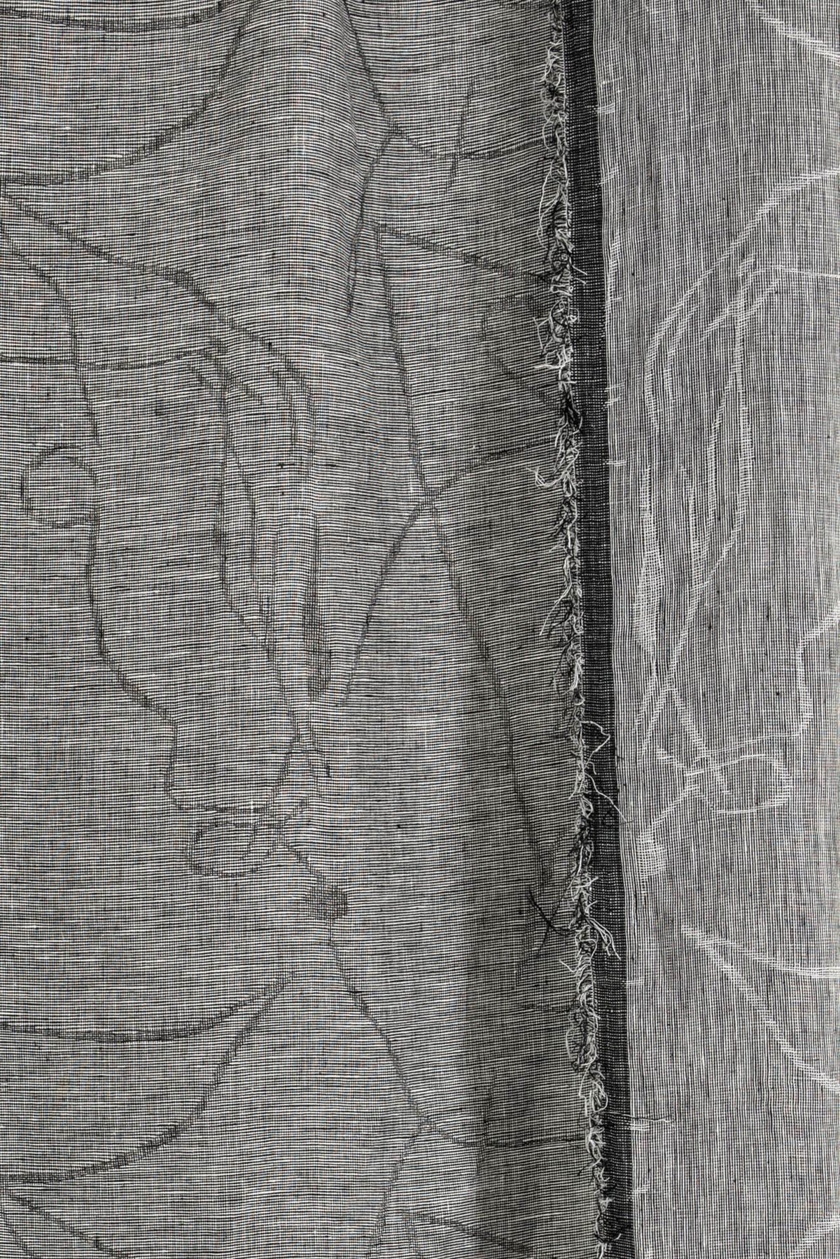 Black and white abstract line print fabric with frayed edge, ideal for apparel sewing projects