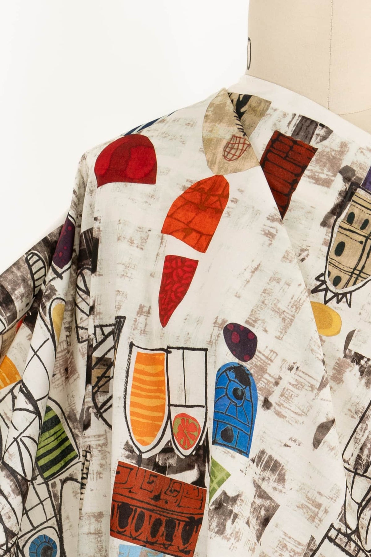 Abstract geometric print fabric with bold shapes and vibrant colors, ideal for apparel sewing projects