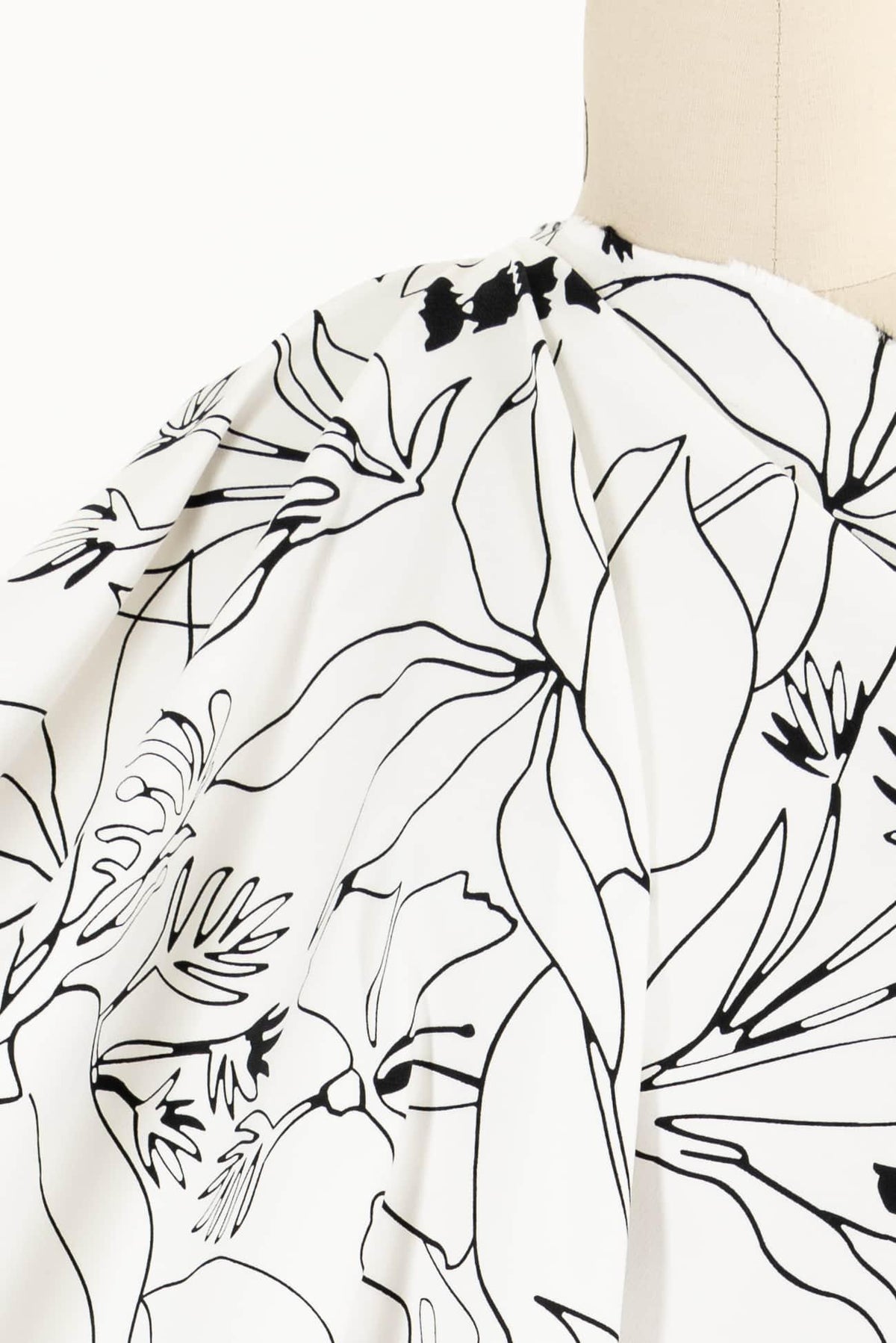 Black and white floral print fabric draped on mannequin, ideal for apparel sewing projects