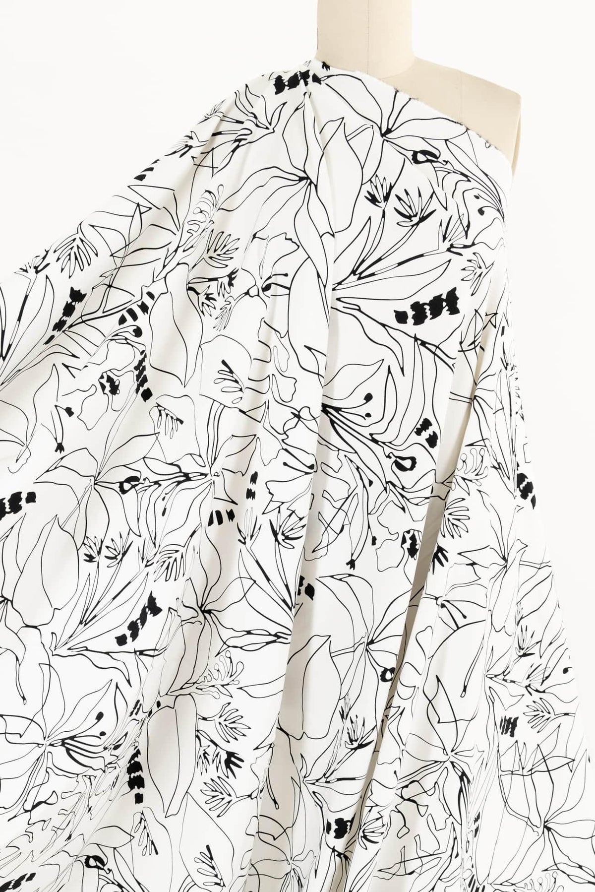 Black and white floral print fabric draped on mannequin, ideal for apparel sewing projects