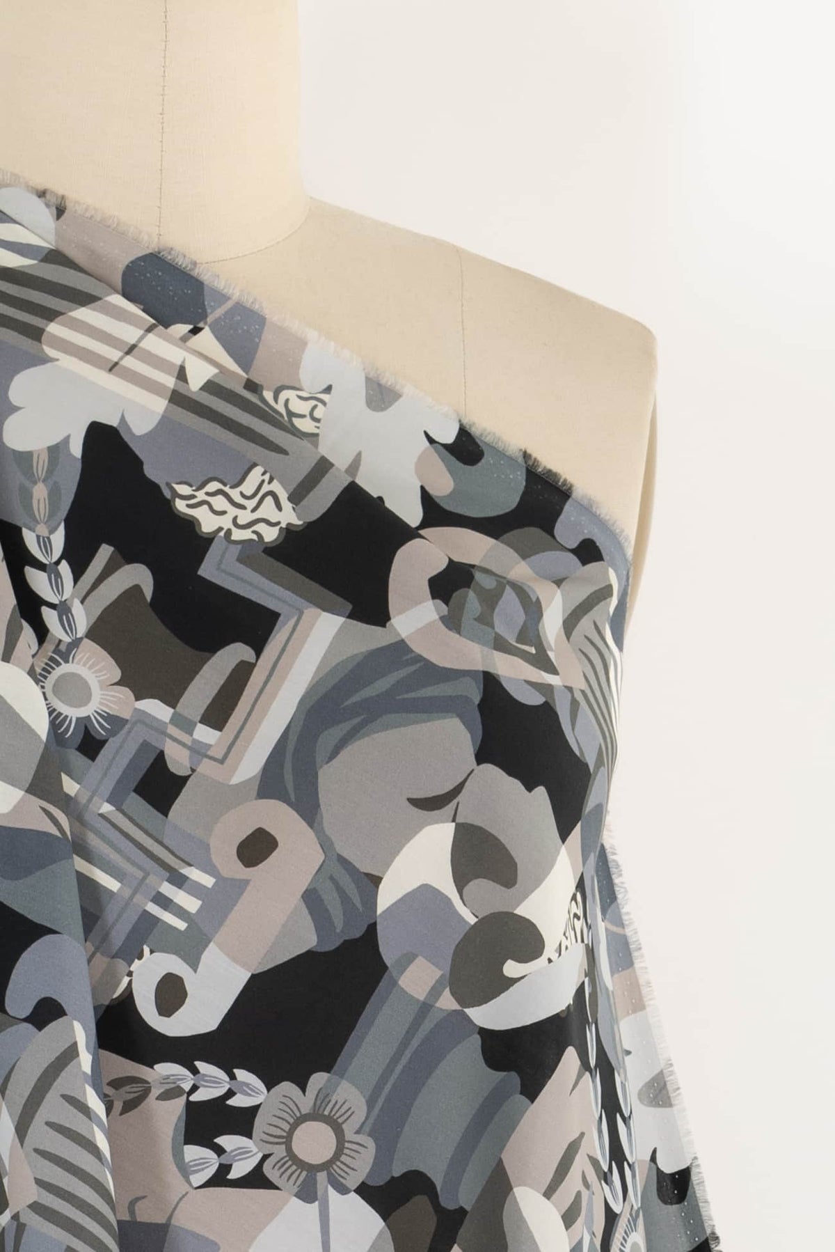 Abstract geometric floral print fabric in gray, black, and beige on mannequin