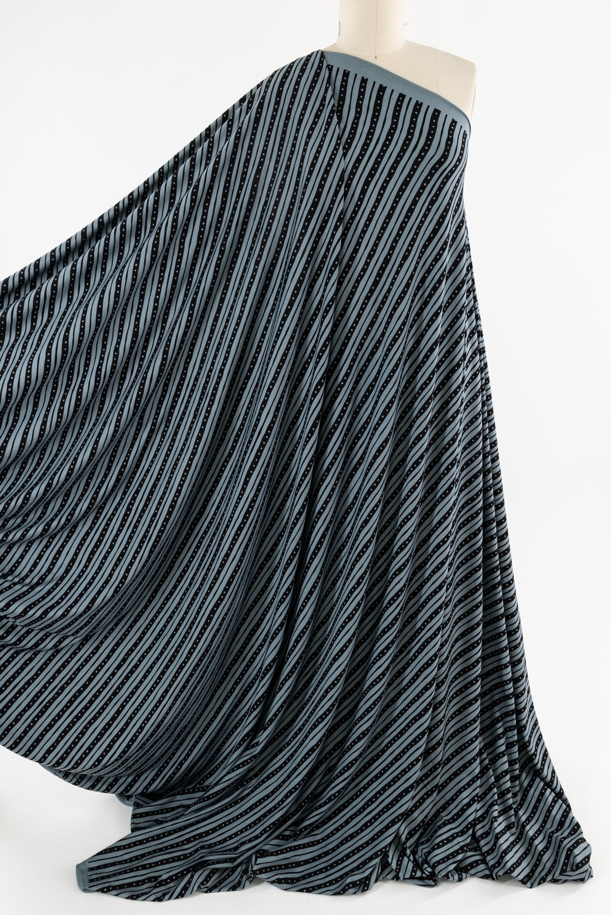 Blue and black striped knit fabric draped on mannequin, ideal for apparel sewing projects