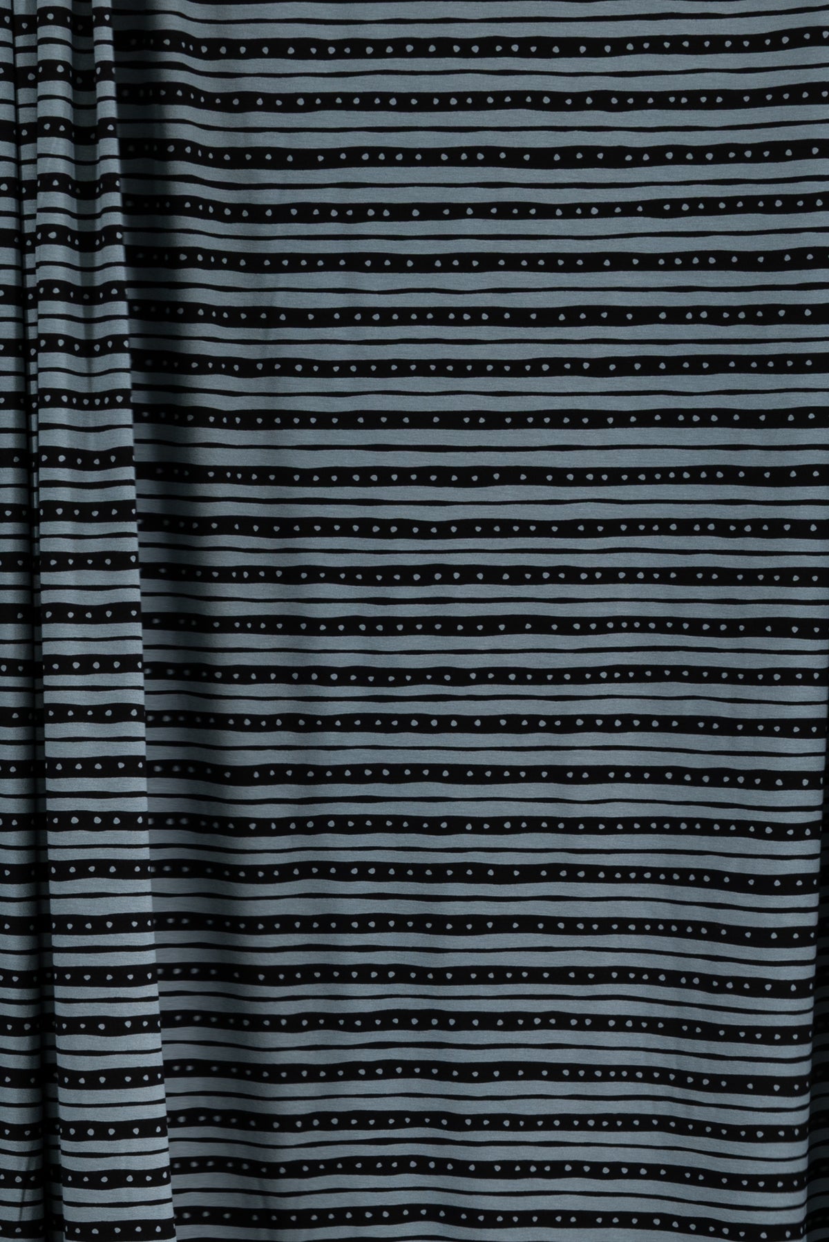 Gray and black striped fabric with dotted pattern, ideal for apparel sewing and fashion projects