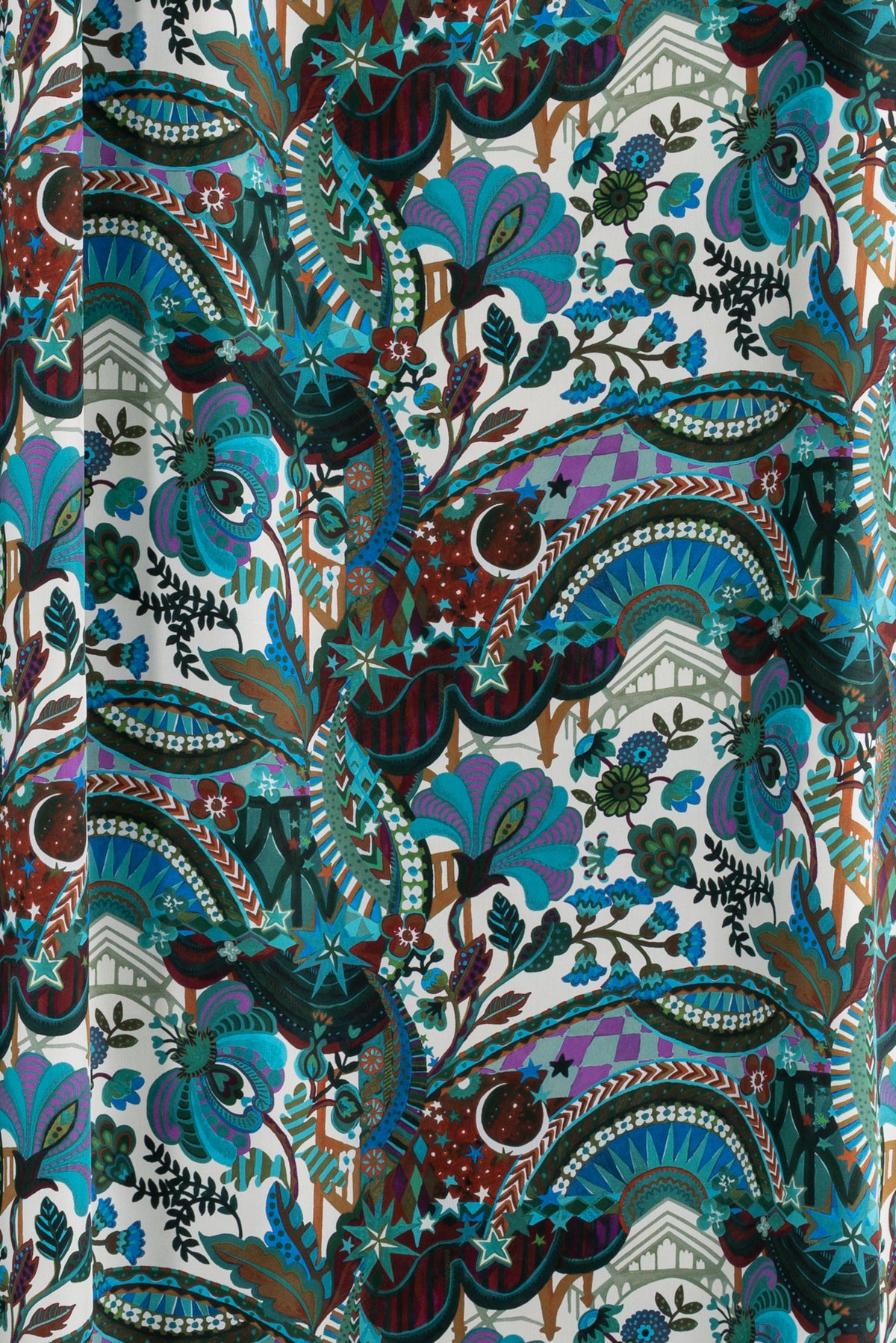 Vibrant paisley floral fabric with stars, moons, and geometric patterns in teal, purple, and burgundy for apparel sewing