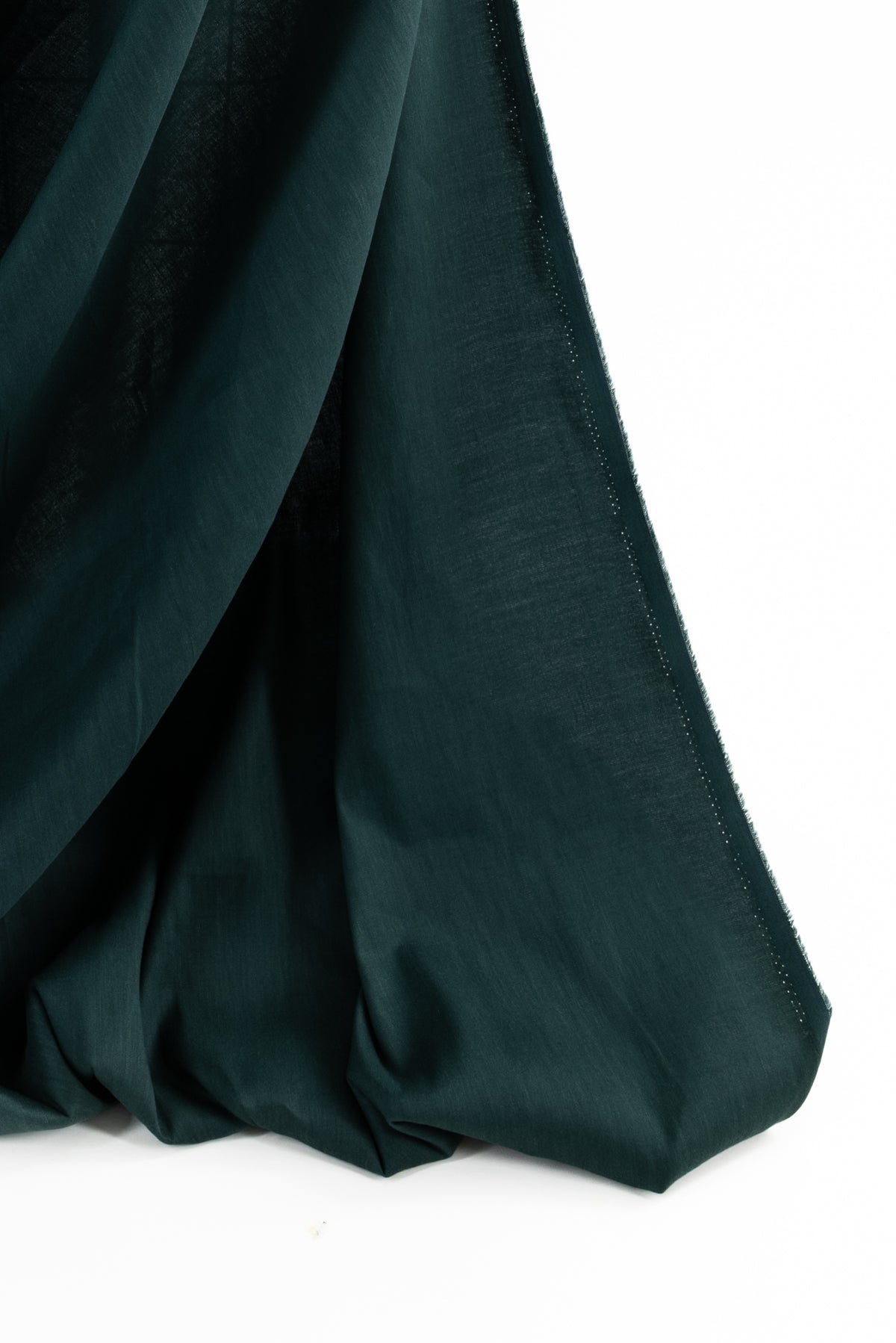 Deep green solid fabric with soft drape, ideal for apparel and sewing projects
