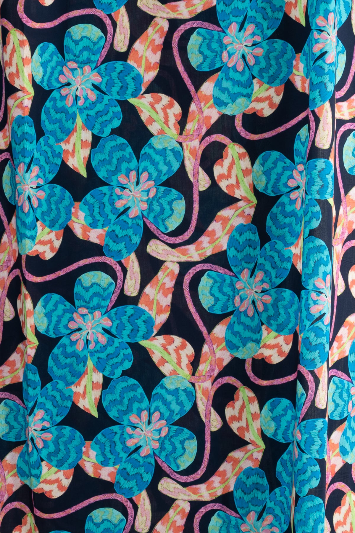 Vibrant floral fabric with turquoise blooms and orange leaves on black background, ideal for sewing projects.