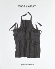 Dark gray striped linen apron with pockets, ideal for sewing and crafting projects