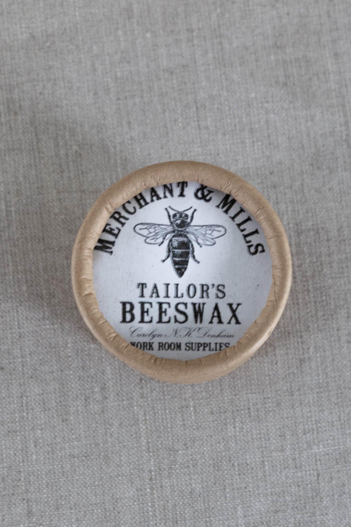 Tailor's beeswax by Merchant & Mills on linen fabric, sewing supply for quilting and apparel projects