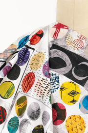 Colorful abstract geometric print fabric draped on mannequin, ideal for apparel sewing and creative projects