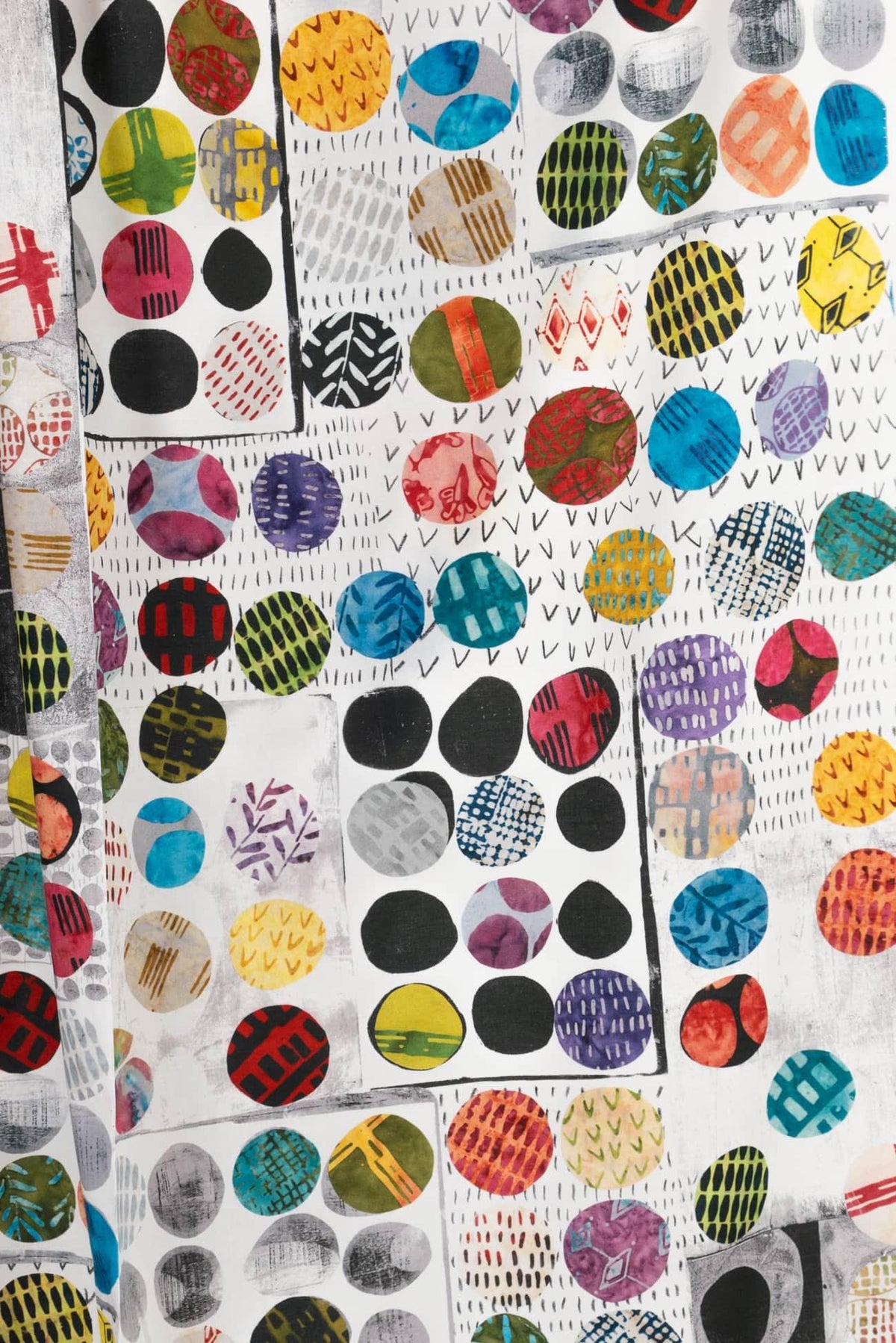 Colorful geometric print fabric with circles, stripes, and abstract patterns for apparel and quilting