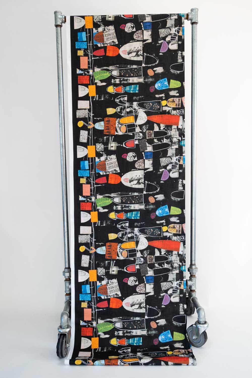 Black abstract print fabric with colorful geometric shapes, ideal for apparel and quilting projects