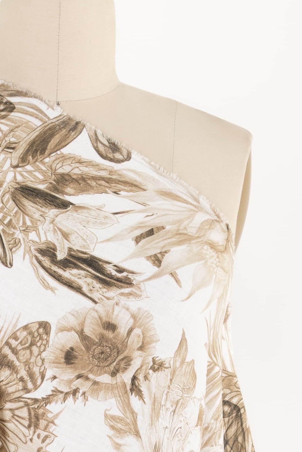 Floral print fabric with sepia-toned botanical design on mannequin, ideal for apparel sewing projects