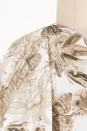 Floral and butterfly print fabric in brown tones, ideal for apparel sewing and fashion projects