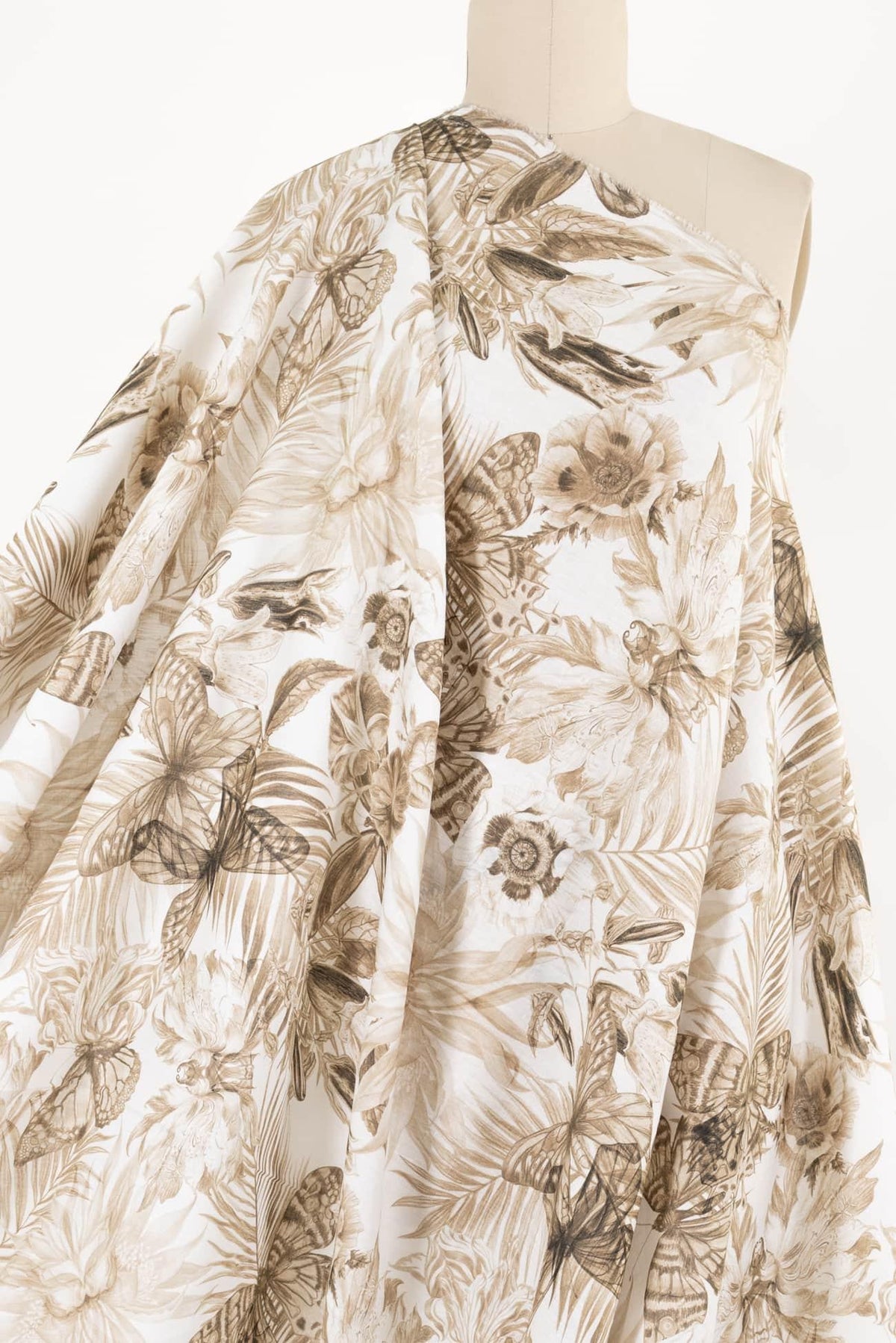 Floral and butterfly print fabric in beige tones, ideal for apparel and creative sewing projects.
