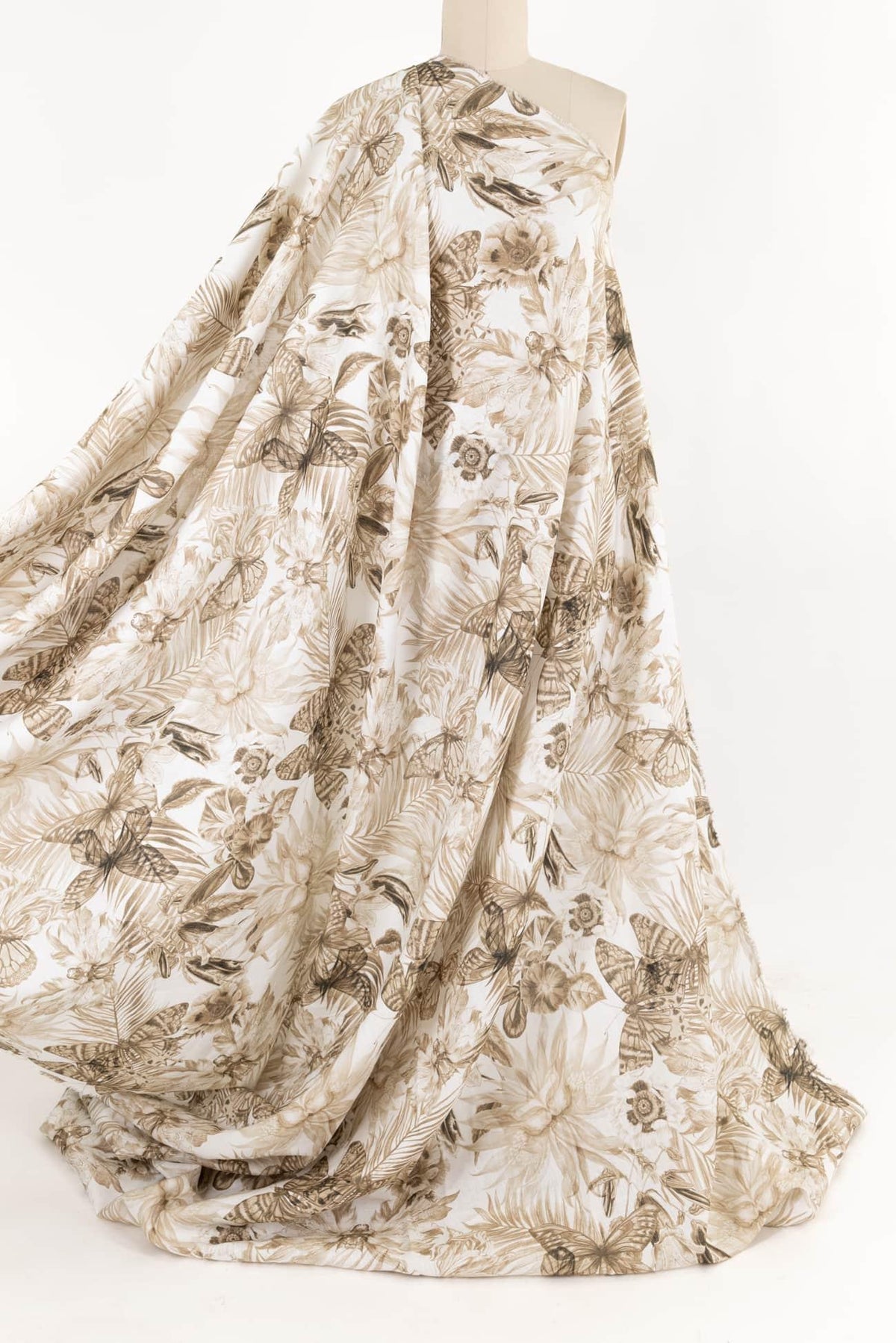 Floral and butterfly print fabric in beige tones, ideal for apparel and sewing projects