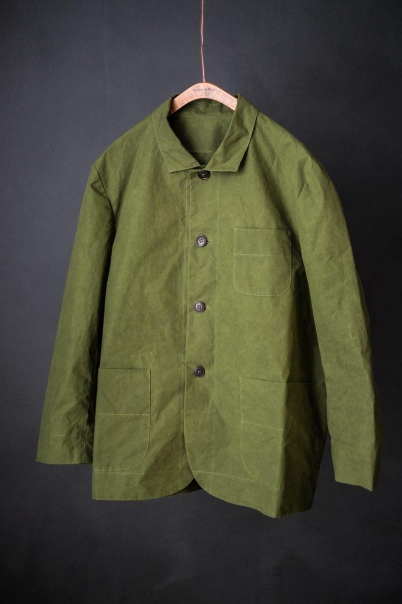 Olive green button-up jacket with patch pockets, crafted from durable woven fabric, ideal for sewing projects.