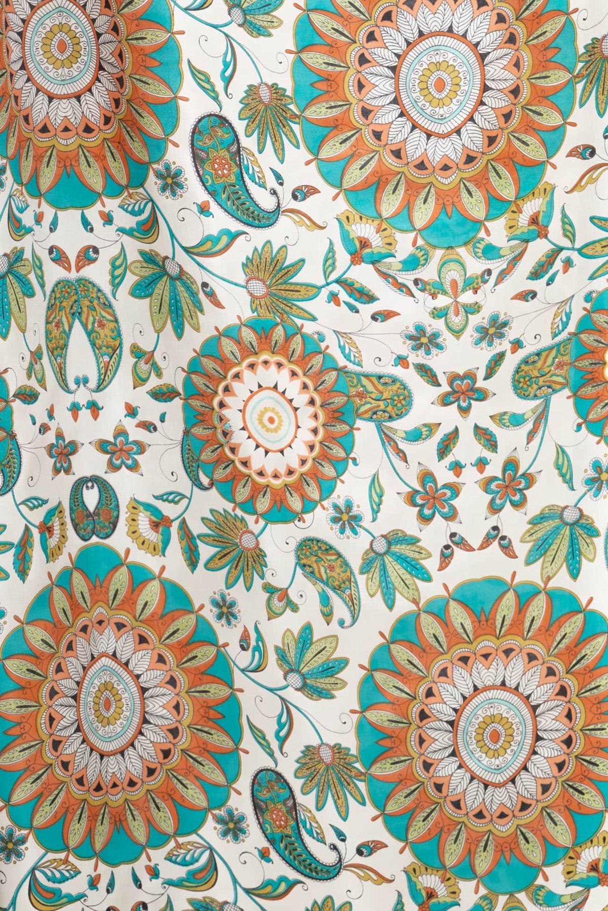 Vibrant floral and paisley print fabric in teal, orange, and cream — ideal for apparel, quilting, and creative sewing projects.
