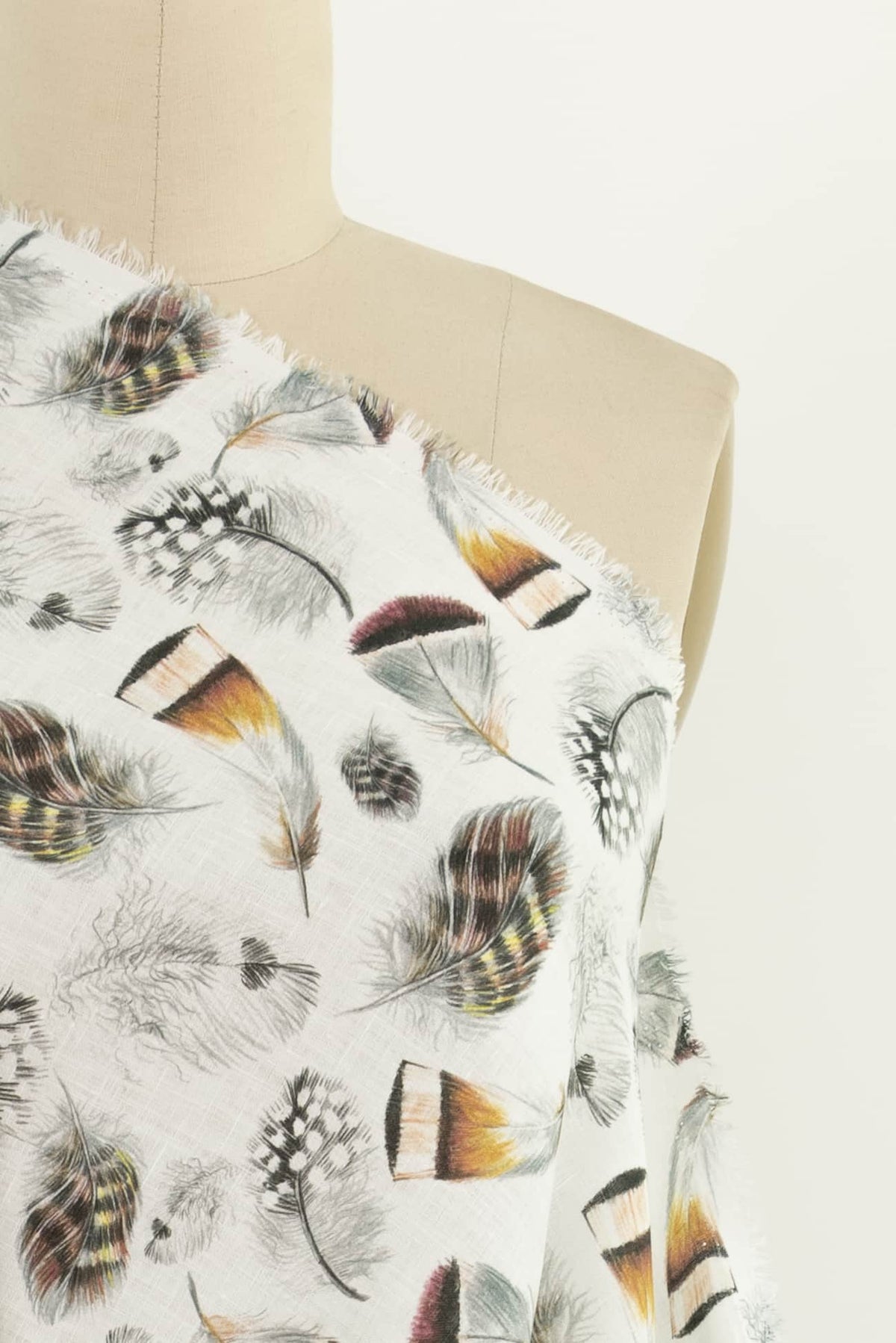 Feather print fabric on mannequin, ideal for apparel sewing and fashion projects