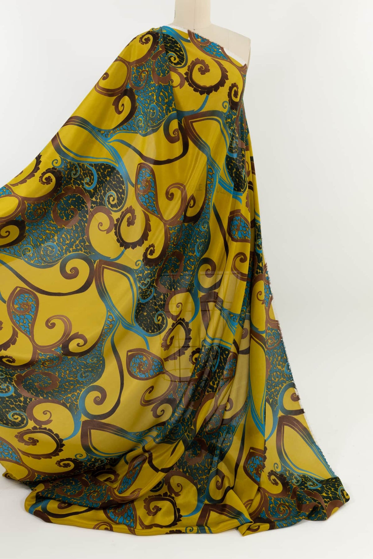 Yellow and blue abstract swirl print fabric draped on mannequin, ideal for apparel sewing projects