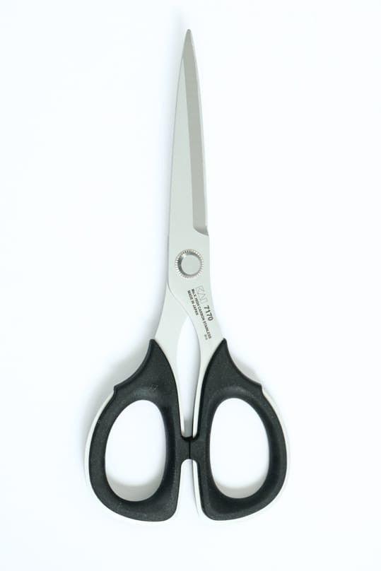 Sharp fabric scissors with black ergonomic handles for precise cutting of cotton, linen, and knit fabrics
