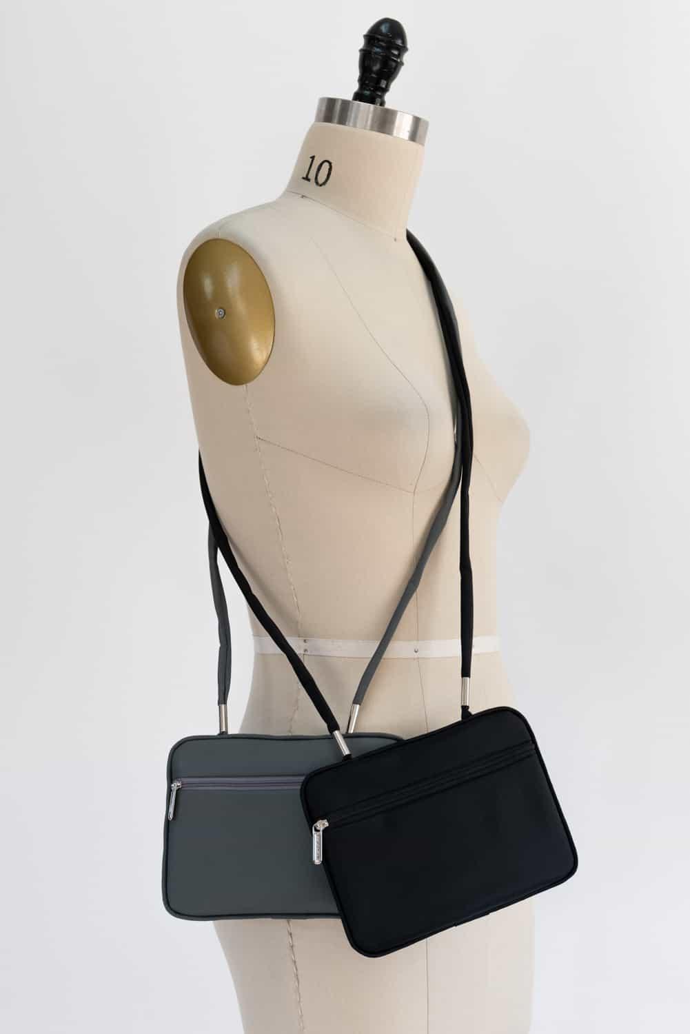 Black and gray crossbody bags on dress form, ideal for sewing projects and fashion design