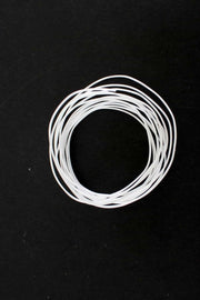 Coiled white elastic cord for sewing and crafting projects