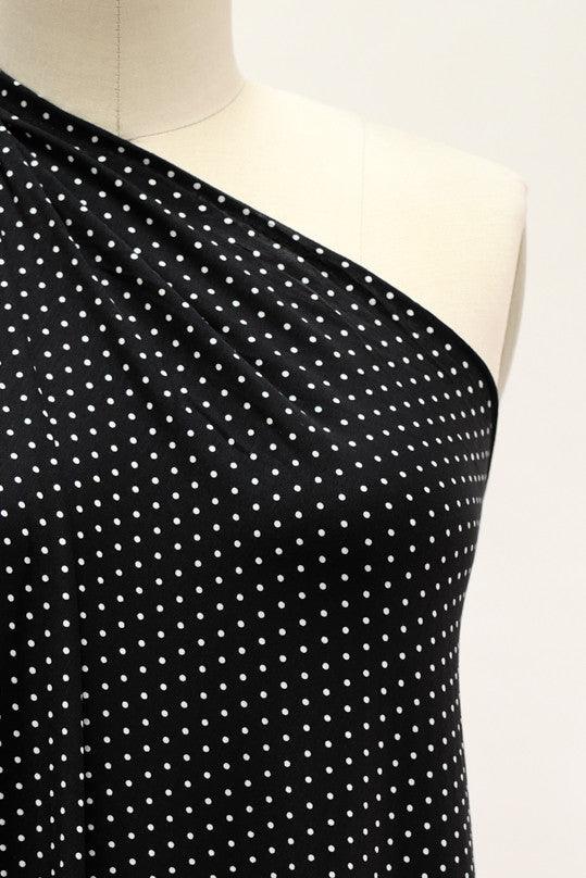 Black and white polka dot fabric draped on mannequin, ideal for apparel sewing projects