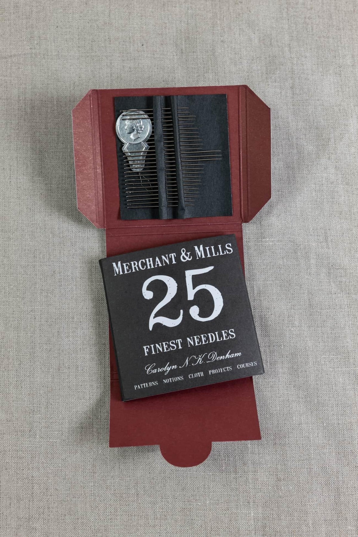 Merchant & Mills 25 finest sewing needles in red box, ideal for fabric projects and apparel crafting