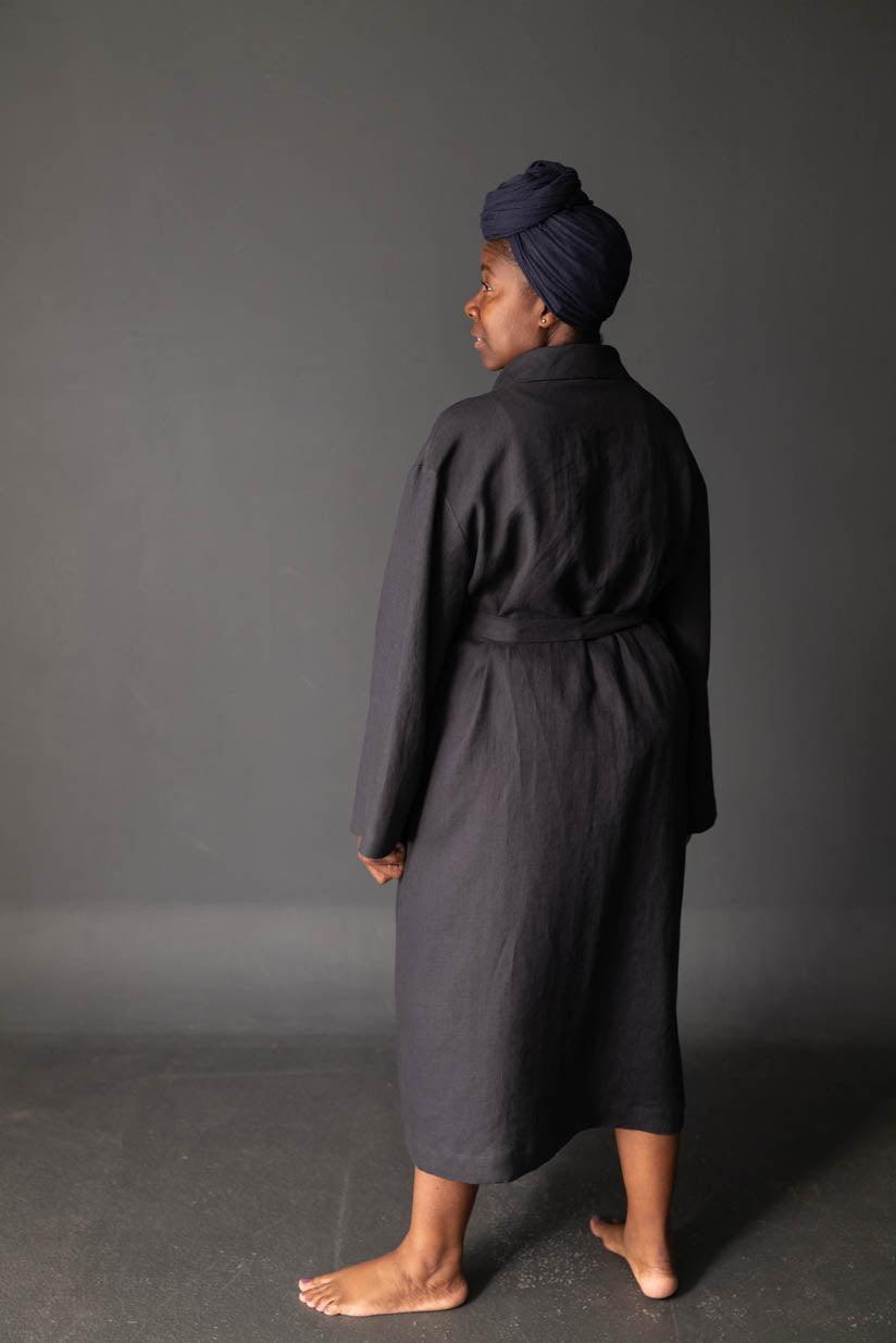 Woman in dark linen robe with turban, showcasing fabric drape and texture for sewing projects