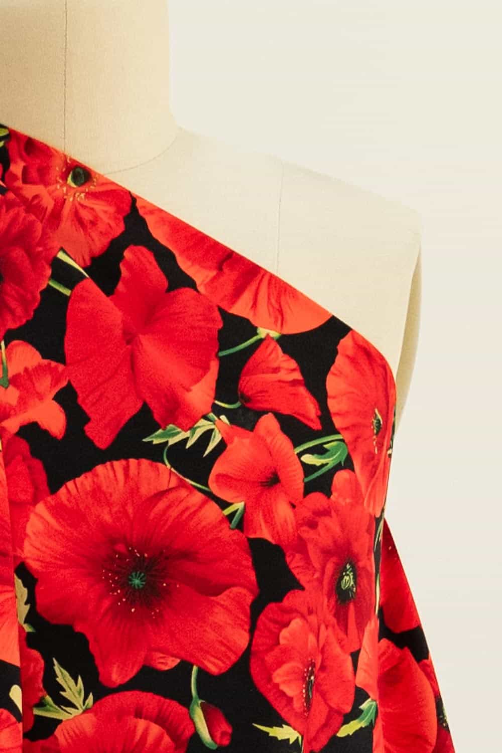 Vibrant red poppy floral fabric on mannequin, ideal for apparel sewing and fashion projects