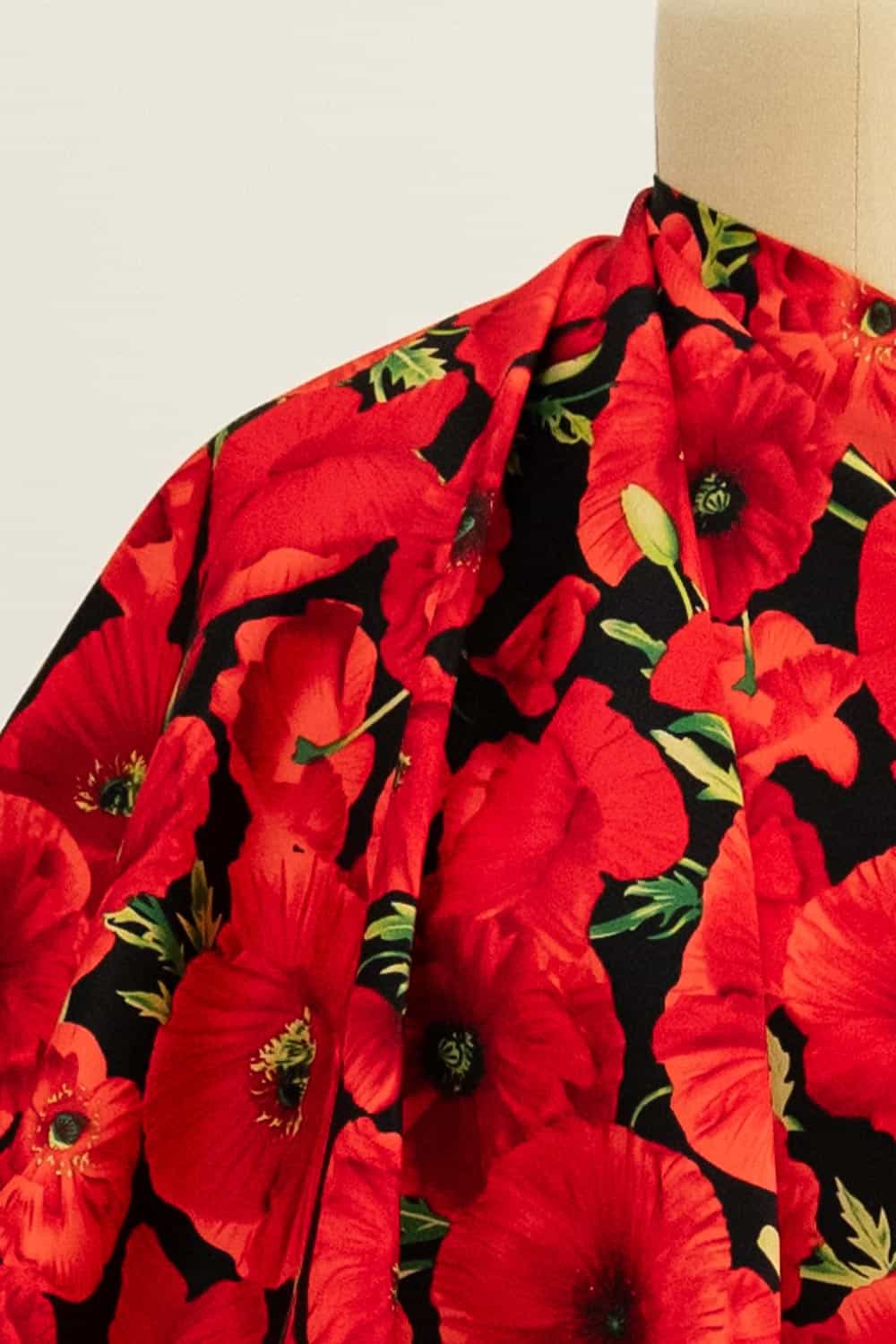Vibrant red poppy floral fabric on mannequin, ideal for apparel sewing and fashion projects