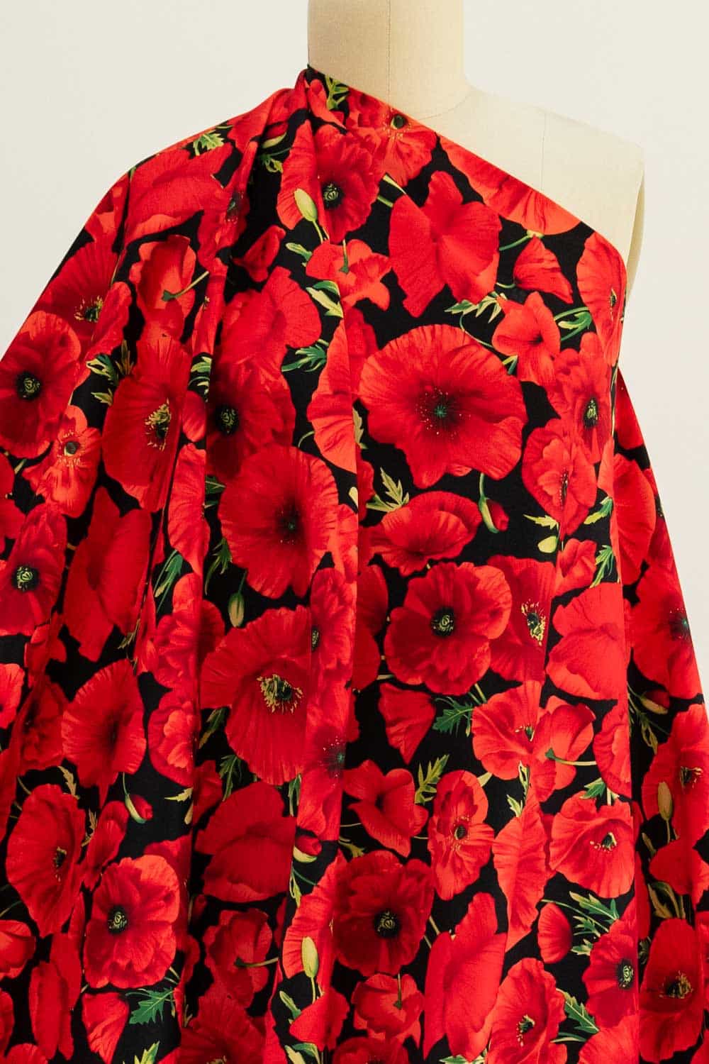 Vibrant red poppy floral print fabric on mannequin, ideal for apparel sewing projects