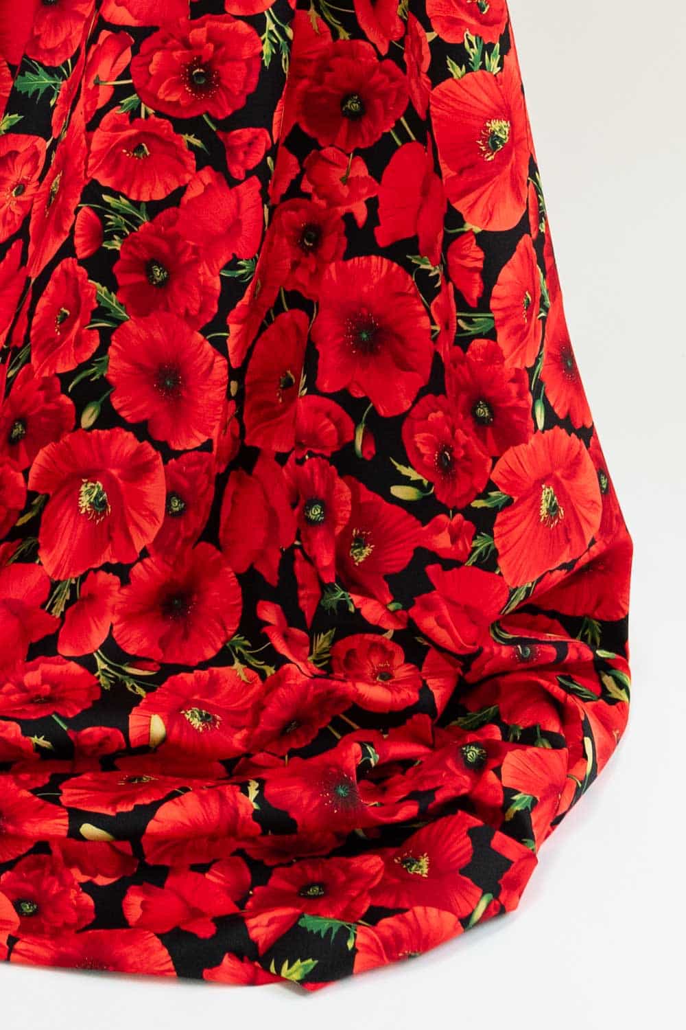Red poppy floral fabric on black background, ideal for apparel and quilting projects