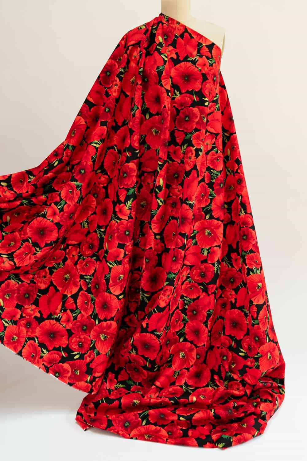 Red poppy floral print fabric on mannequin, ideal for apparel sewing and quilting projects
